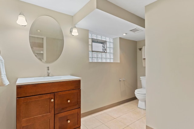 bathroom featuring vanity, visible vents, baseboards, tile patterned flooring, and toilet