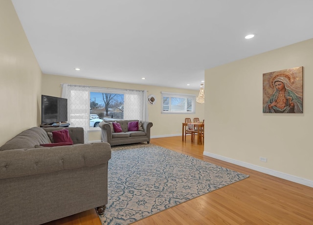 living room with baseboards, wood finished floors, and recessed lighting