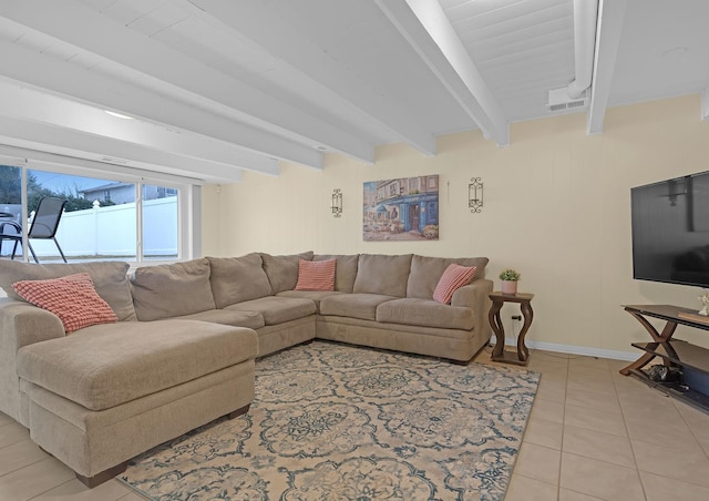 living room featuring light tile patterned floors, baseboards, and beam ceiling