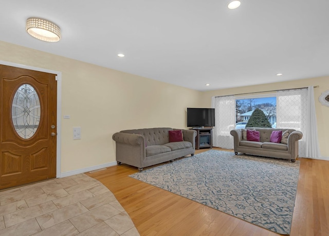 living area with recessed lighting, baseboards, and wood finished floors