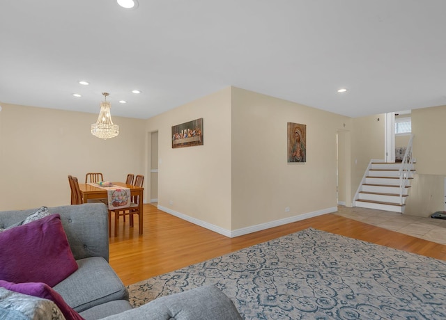 living room featuring stairs, wood finished floors, and recessed lighting