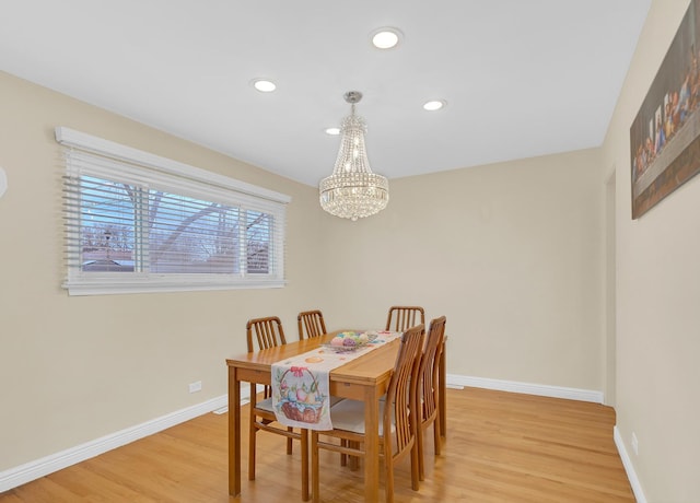 dining space featuring light wood-style flooring, baseboards, a notable chandelier, and recessed lighting