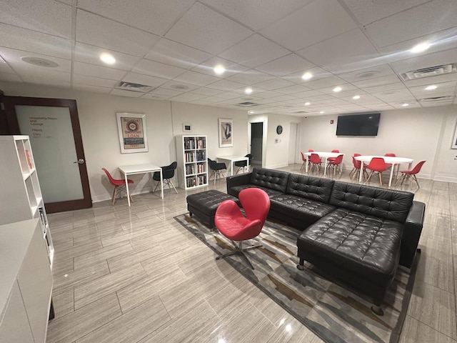 living room featuring baseboards, recessed lighting, a paneled ceiling, and visible vents