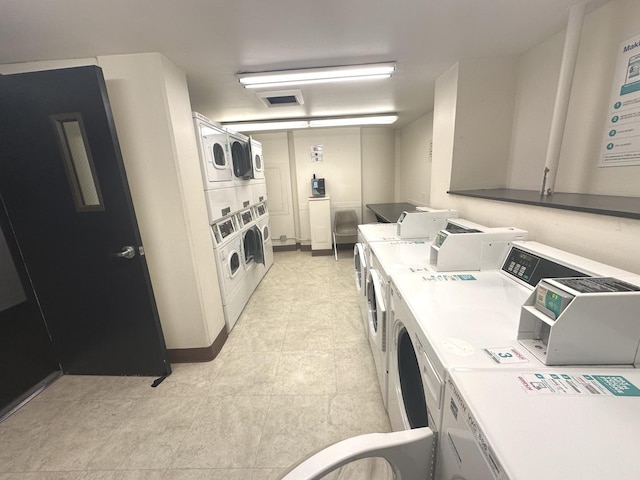 common laundry area with washer and dryer, stacked washing maching and dryer, and visible vents