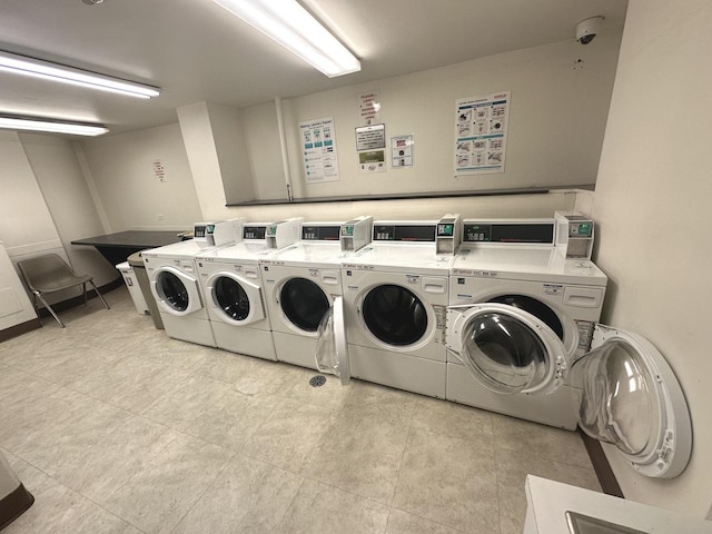 community laundry room with light tile patterned floors and independent washer and dryer