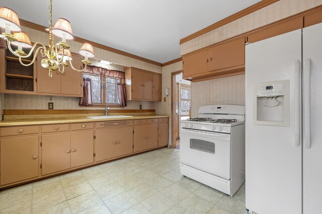 11040 W Cleveland Rd, Mokena, IL 60448 - kitchen with white appliances, light flooring, a sink, light countertops, and a chandelier