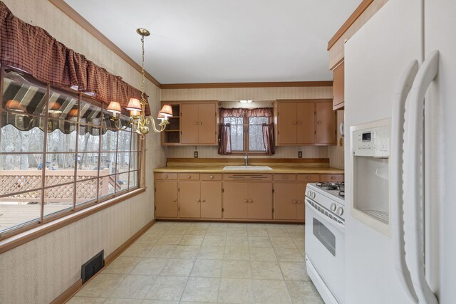 11040 W Cleveland Rd, Mokena, IL 60448 - kitchen with white appliances, a sink, wallpapered walls, light countertops, and a chandelier