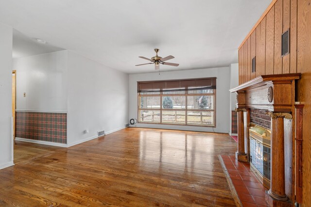 11040 W Cleveland Rd, Mokena, IL 60448 - unfurnished living room featuring a glass covered fireplace, ceiling fan, baseboards, and dark wood finished floors