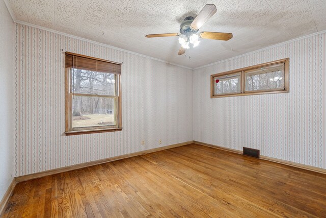 11040 W Cleveland Rd, Mokena, IL 60448 - unfurnished room with crown molding, light wood finished floors, healthy amount of natural light, a ceiling fan, and baseboards