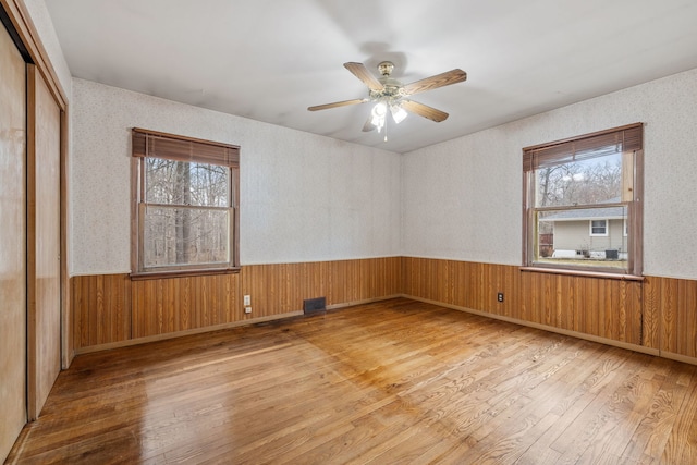 11040 W Cleveland Rd, Mokena, IL 60448 - unfurnished room featuring hardwood / wood-style flooring, a wainscoted wall, plenty of natural light, ceiling fan, and wood walls