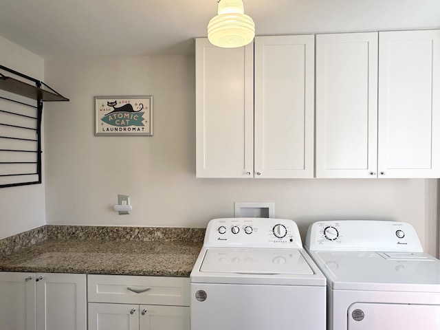 washroom with cabinet space and washer and clothes dryer