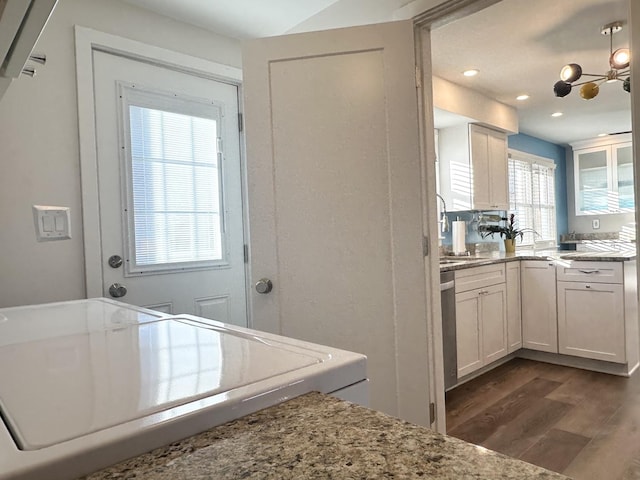 kitchen with light stone counters, recessed lighting, dark wood-style flooring, white cabinets, and dishwasher