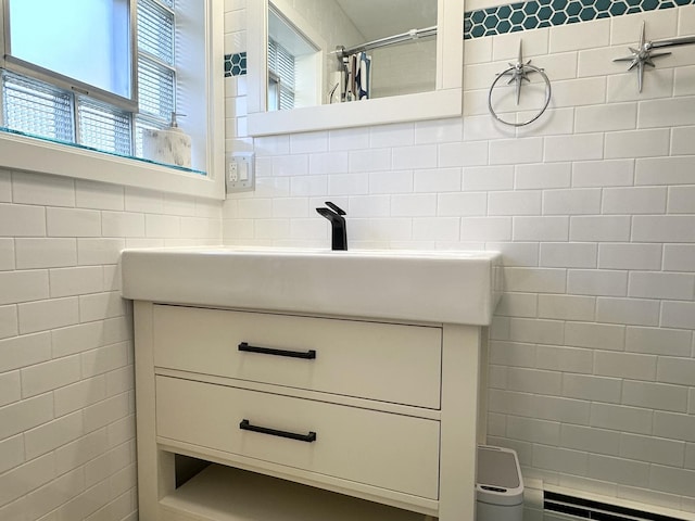 bathroom with backsplash, vanity, and tile walls