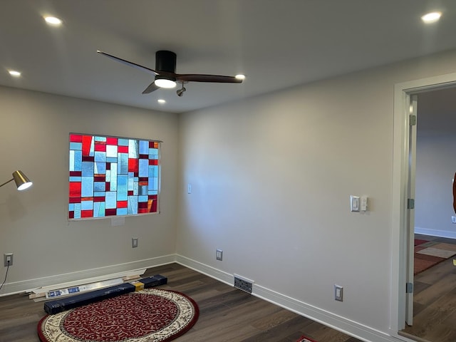 interior space featuring dark wood-style flooring, visible vents, and baseboards