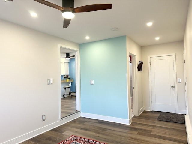 interior space with ceiling fan, recessed lighting, wood finished floors, and baseboards