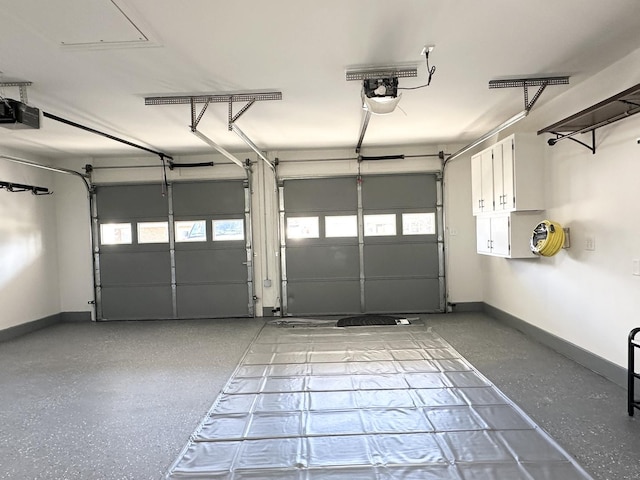 garage with baseboards and a garage door opener