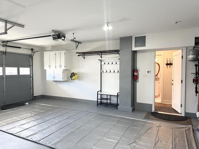 garage featuring baseboards and a garage door opener