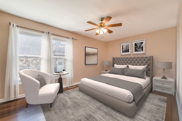 bedroom featuring ceiling fan, wood finished floors, and baseboards