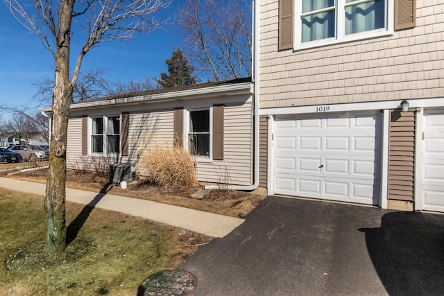 exterior space with driveway and an attached garage