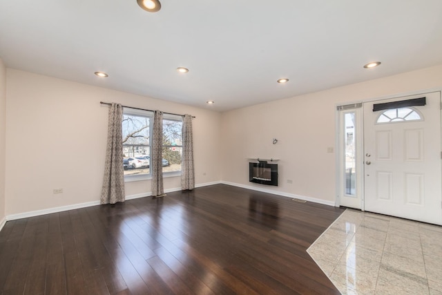 unfurnished living room featuring visible vents, baseboards, wood finished floors, and recessed lighting