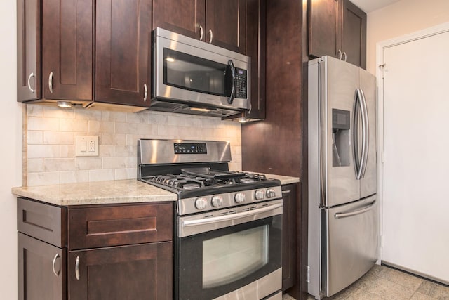 kitchen featuring appliances with stainless steel finishes, dark brown cabinetry, baseboards, and tasteful backsplash