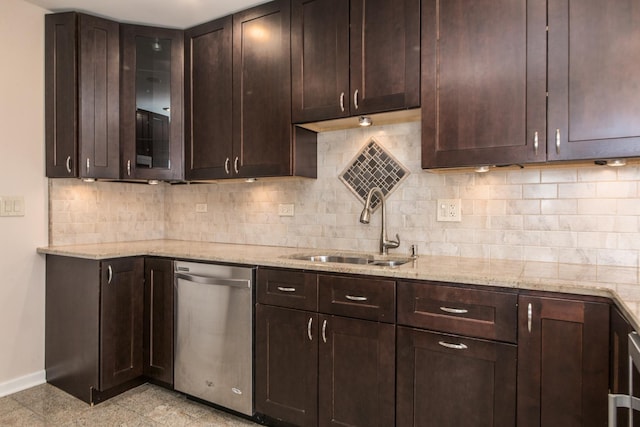 kitchen with a sink, dark brown cabinetry, baseboards, and stainless steel dishwasher