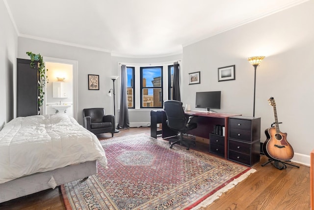 bedroom featuring ornamental molding, baseboards, and wood finished floors