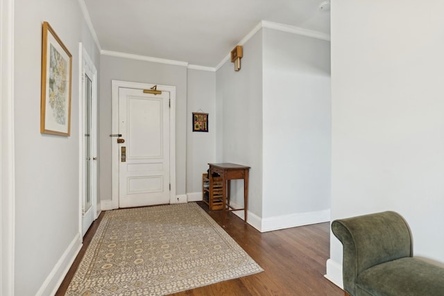 entrance foyer with baseboards, ornamental molding, and wood finished floors