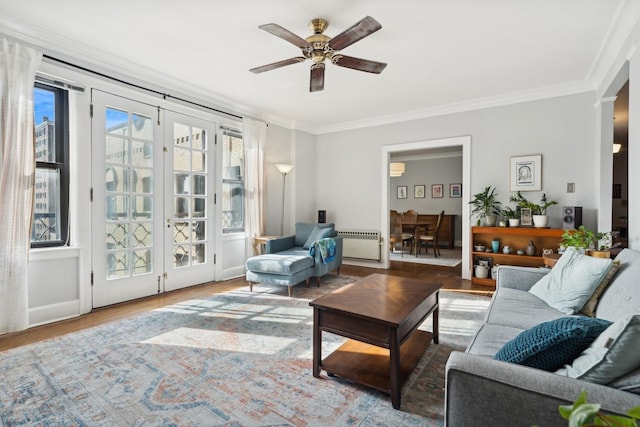 living room featuring ceiling fan, radiator heating unit, wood finished floors, and crown molding