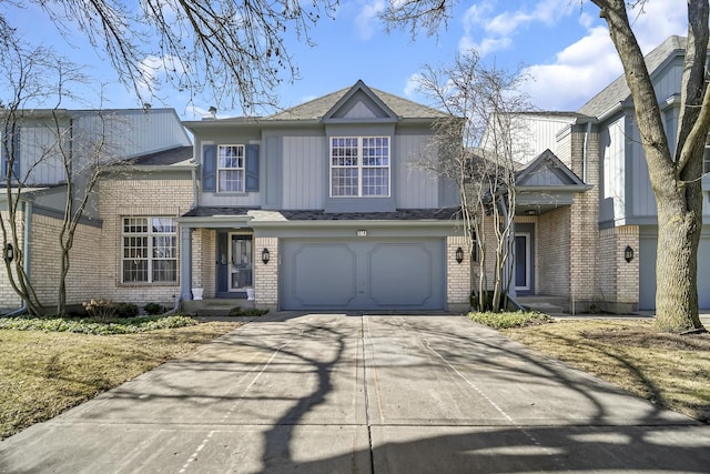 traditional-style house featuring brick siding, driveway, and a garage