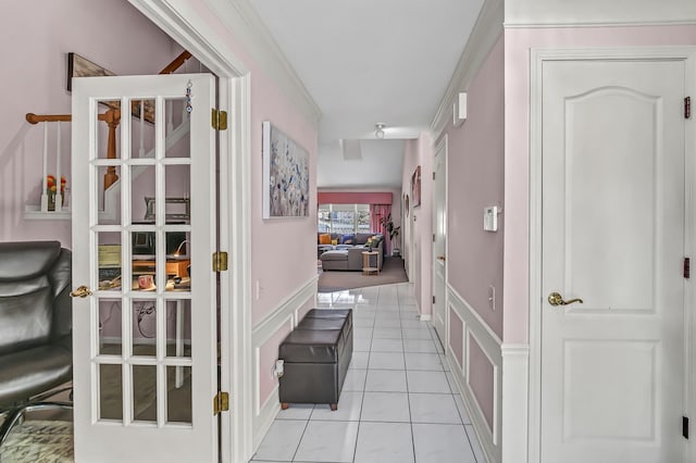 corridor with a decorative wall and light tile patterned floors