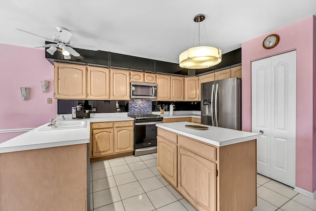 kitchen featuring a sink, light brown cabinetry, stainless steel appliances, light countertops, and light tile patterned flooring
