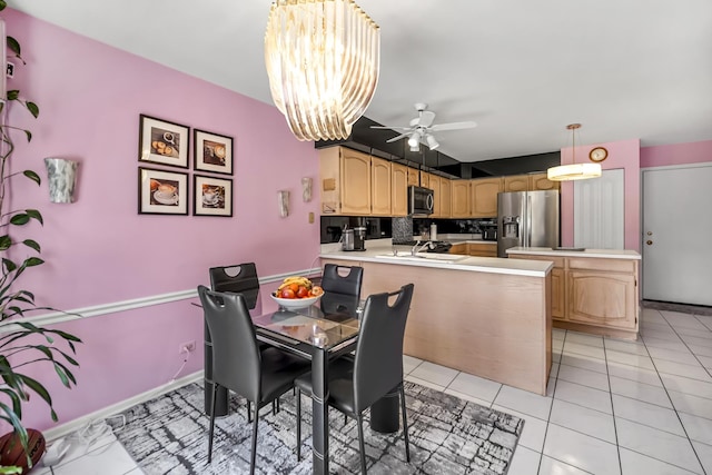 dining space featuring light tile patterned floors and ceiling fan with notable chandelier
