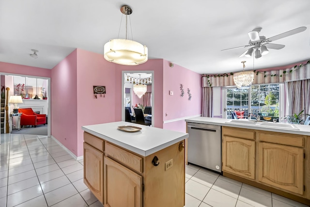 kitchen with light countertops, ceiling fan with notable chandelier, a sink, dishwasher, and light tile patterned flooring