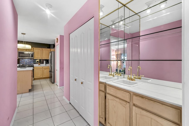 bar with light tile patterned floors, stainless steel appliances, tasteful backsplash, and a sink