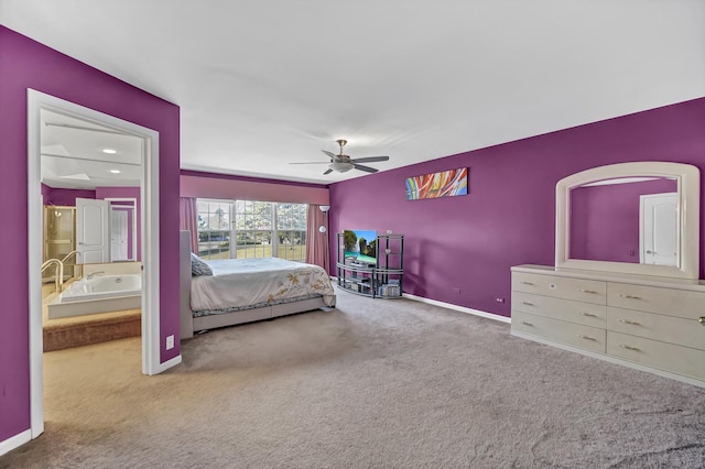 carpeted bedroom featuring ensuite bathroom, baseboards, and a ceiling fan