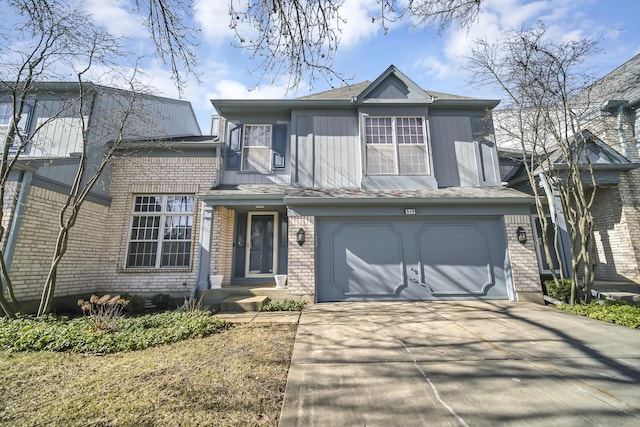 view of front of property with concrete driveway, a garage, and brick siding