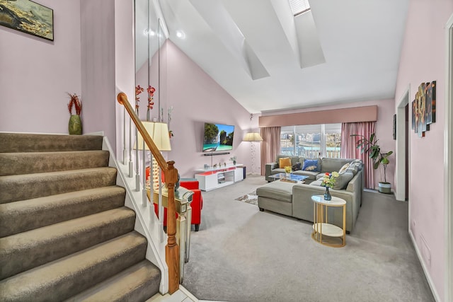 living area with stairway, carpet flooring, baseboards, and high vaulted ceiling