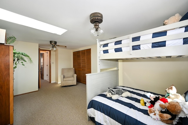 bedroom with a skylight, baseboards, and carpet floors