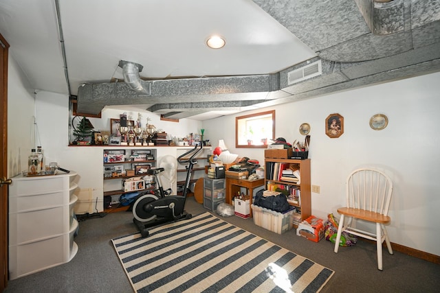 basement with visible vents, carpet, and baseboards