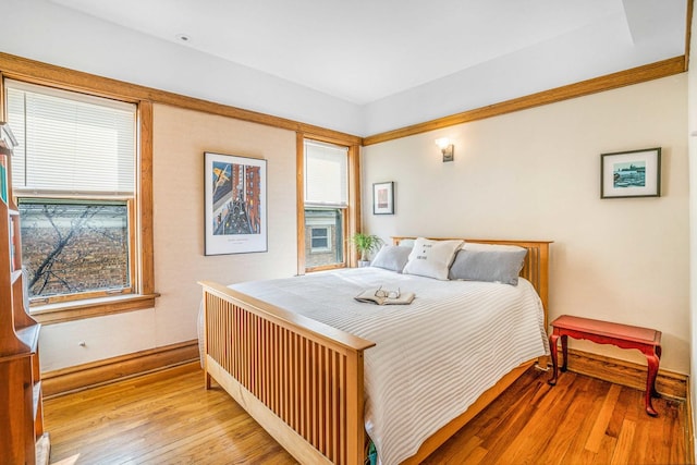 bedroom with baseboards and hardwood / wood-style floors