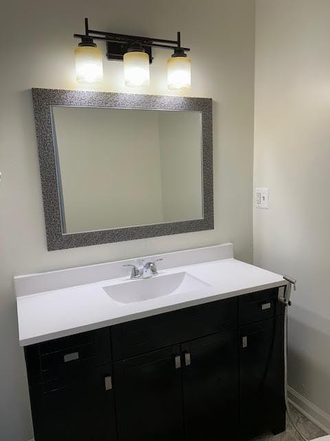 bathroom featuring baseboards and vanity