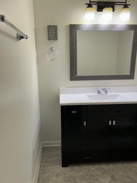 bathroom featuring vanity and baseboards