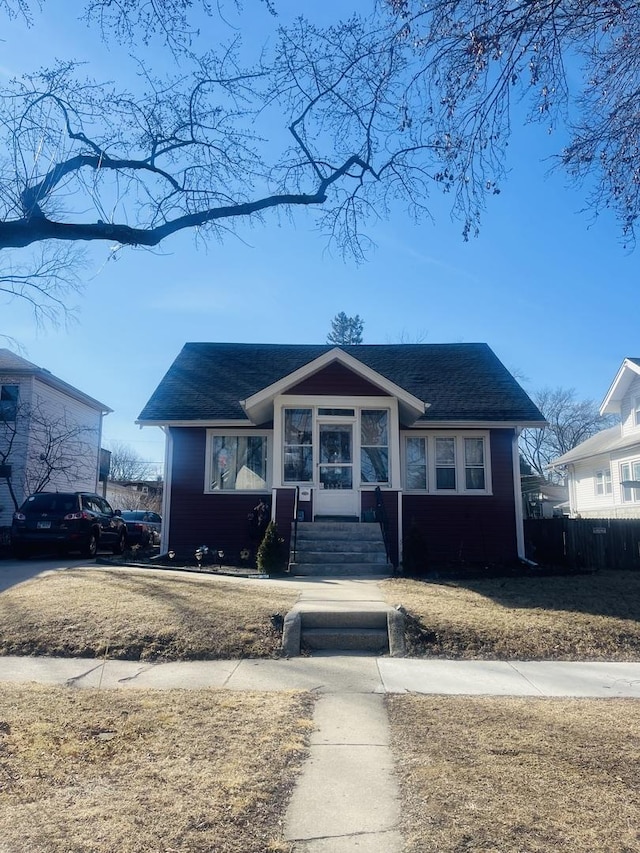 bungalow-style home featuring roof with shingles