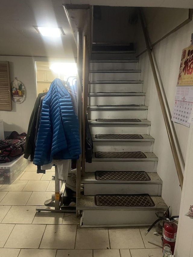 stairs featuring tile patterned floors