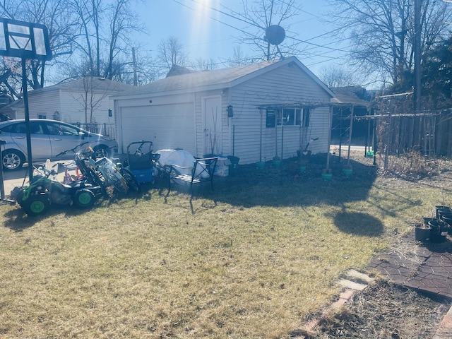 view of property exterior featuring a garage, a lawn, and fence