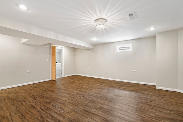 finished below grade area featuring dark wood-type flooring, recessed lighting, visible vents, and baseboards