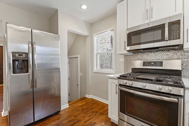 kitchen featuring dark wood finished floors, white cabinetry, stainless steel appliances, and decorative backsplash