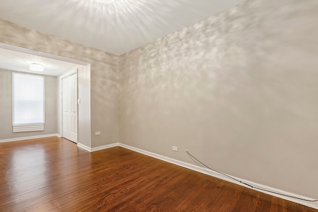 unfurnished room with wood finished floors and baseboards