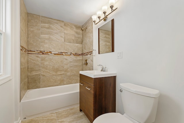 bathroom featuring vanity, toilet, and bathing tub / shower combination